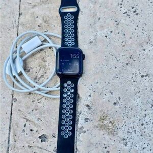 Apple Watch Series 7 Nike with Black Sport Band and White Accent Holes.